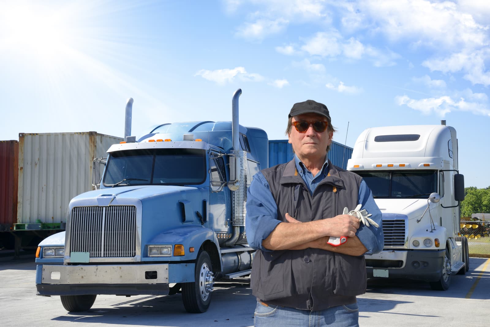 Owner-operator standing in front of his semi trucks
